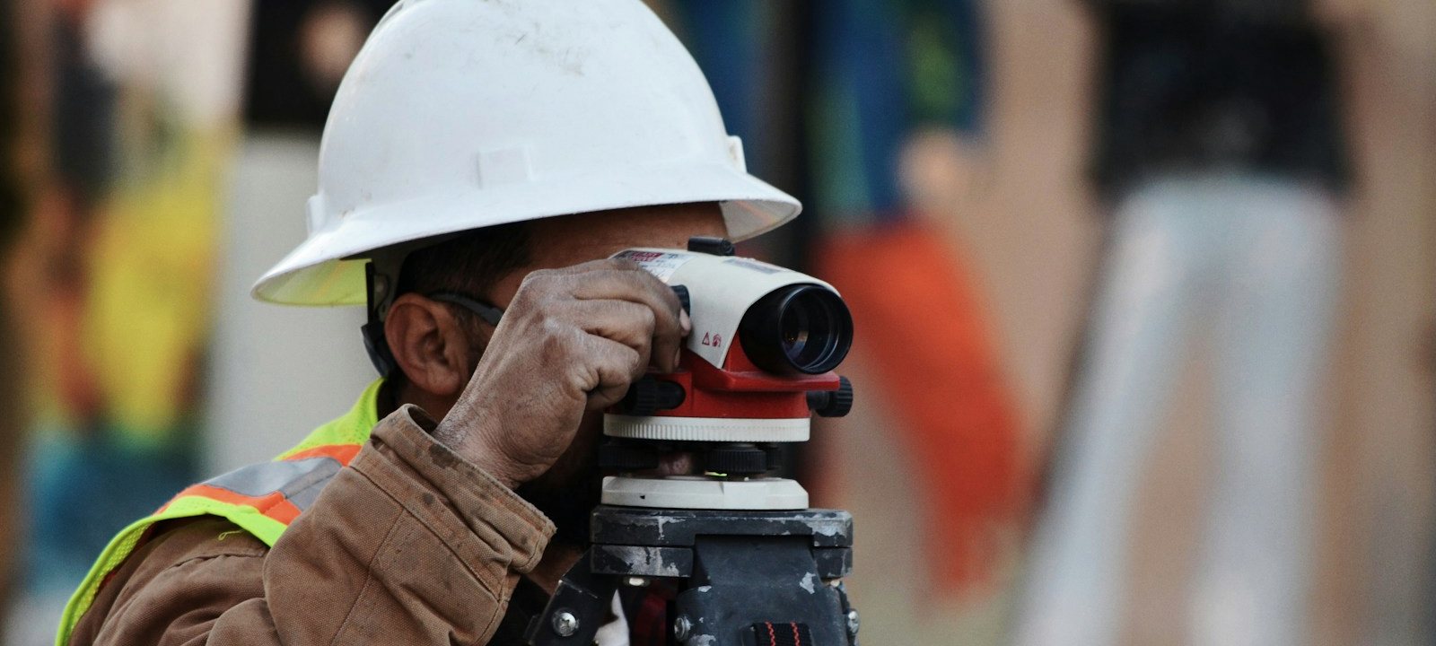 Construction worker using a surveying instrument on a job site
