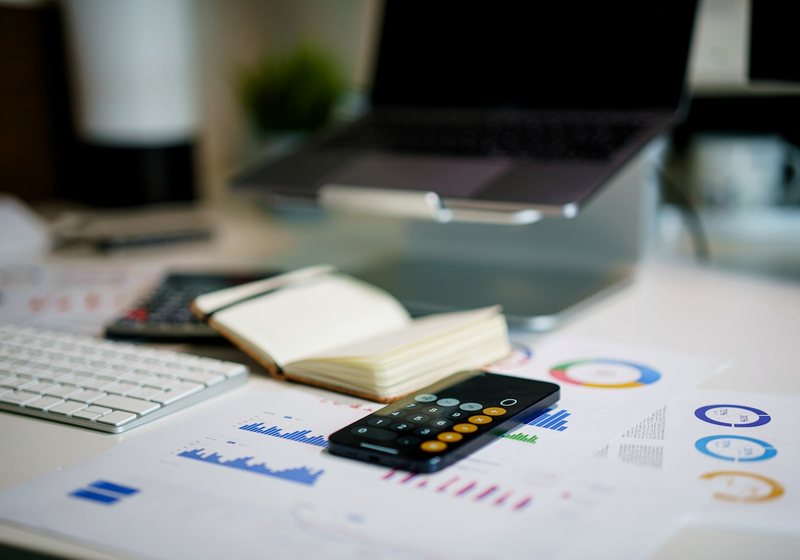 Invoice paperwork and a calculator on a desk