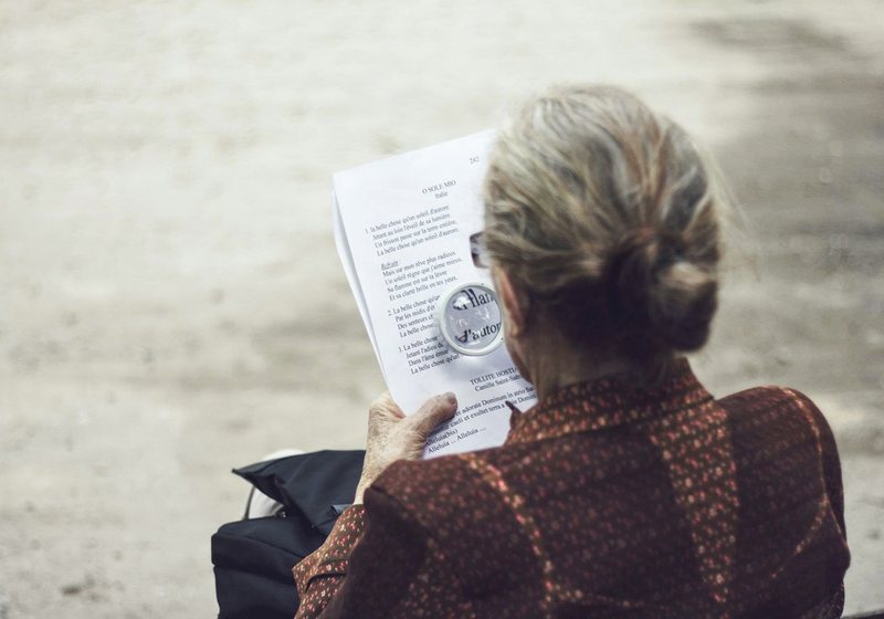 Person reading a document closely