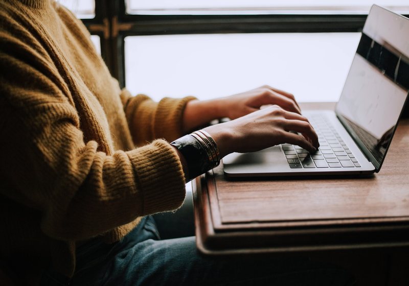 Business owner building a website themselves on a laptop using a drag-and-drop builder