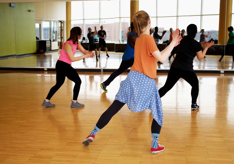 Group fitness class in a studio with mirrored walls