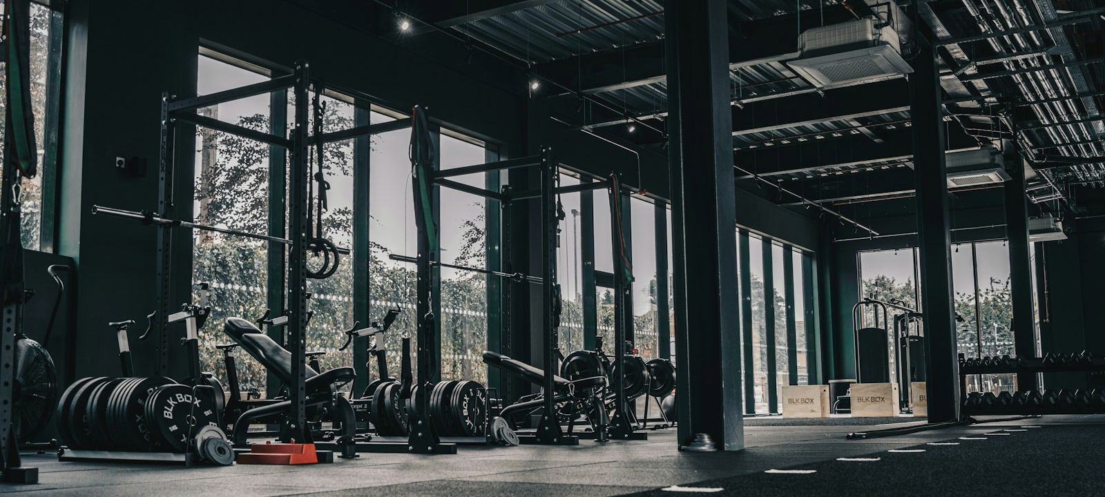 Modern gym interior with weight racks and equipment