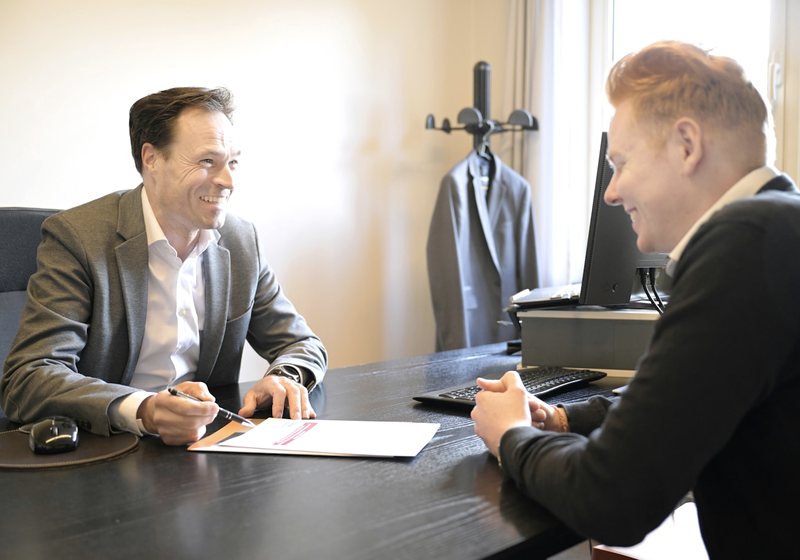 Attorney meeting with a client at an office desk