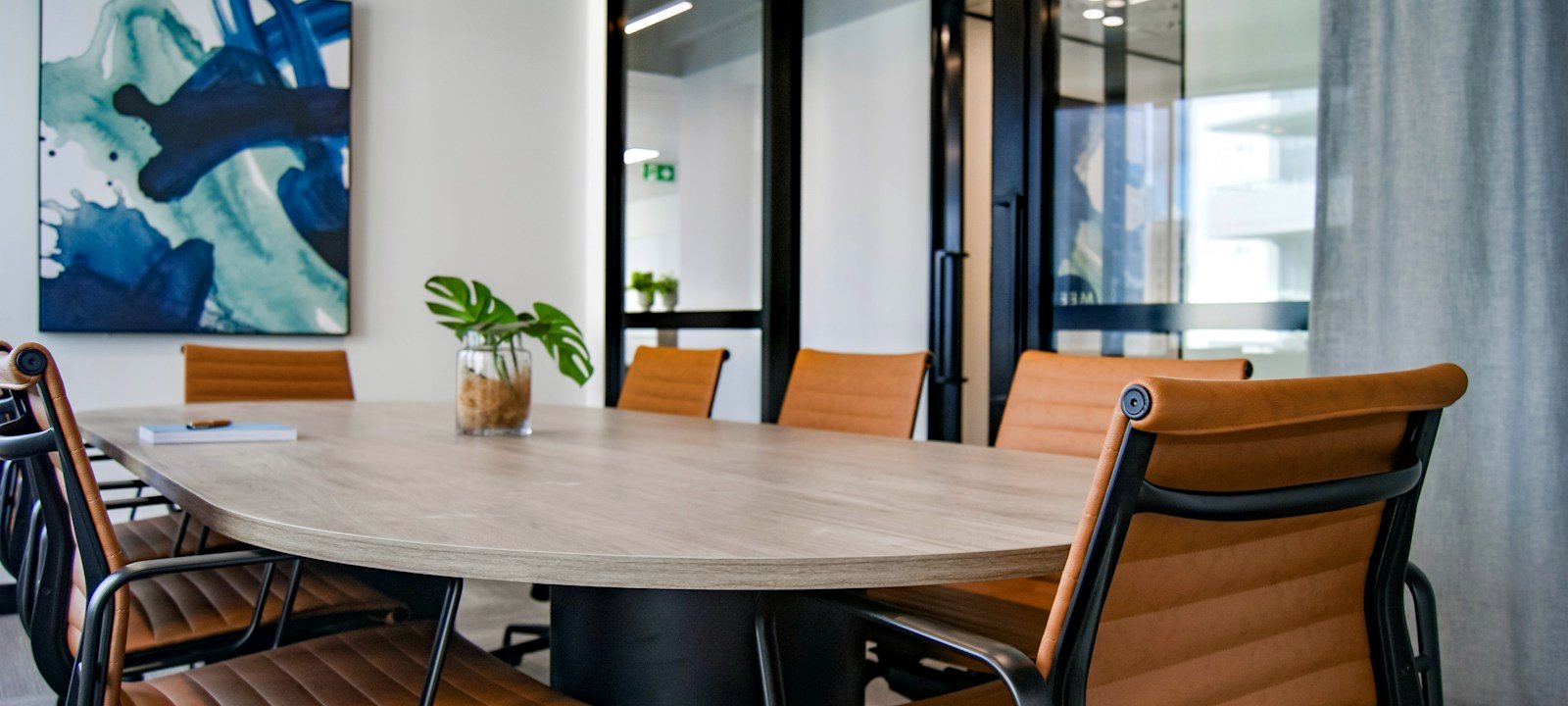 Modern law firm boardroom with leather chairs and a conference table