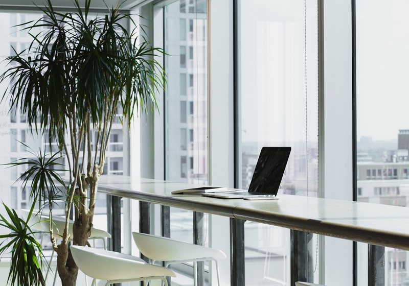 Clean, modern workspace with a laptop by a window