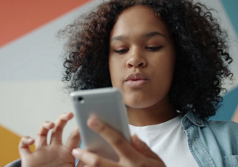 Person looking at a phone screen with a frustrated expression