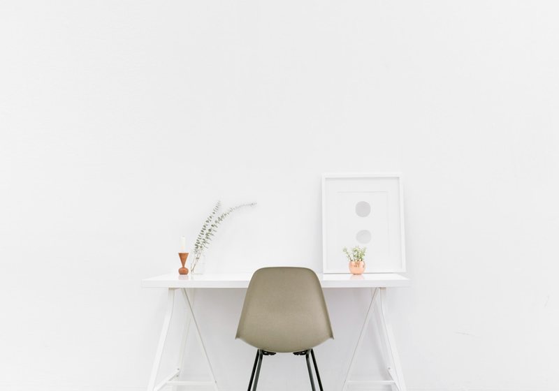 Minimal, clean desk setup with a single chair