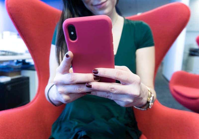 Person holding a phone while getting a manicure